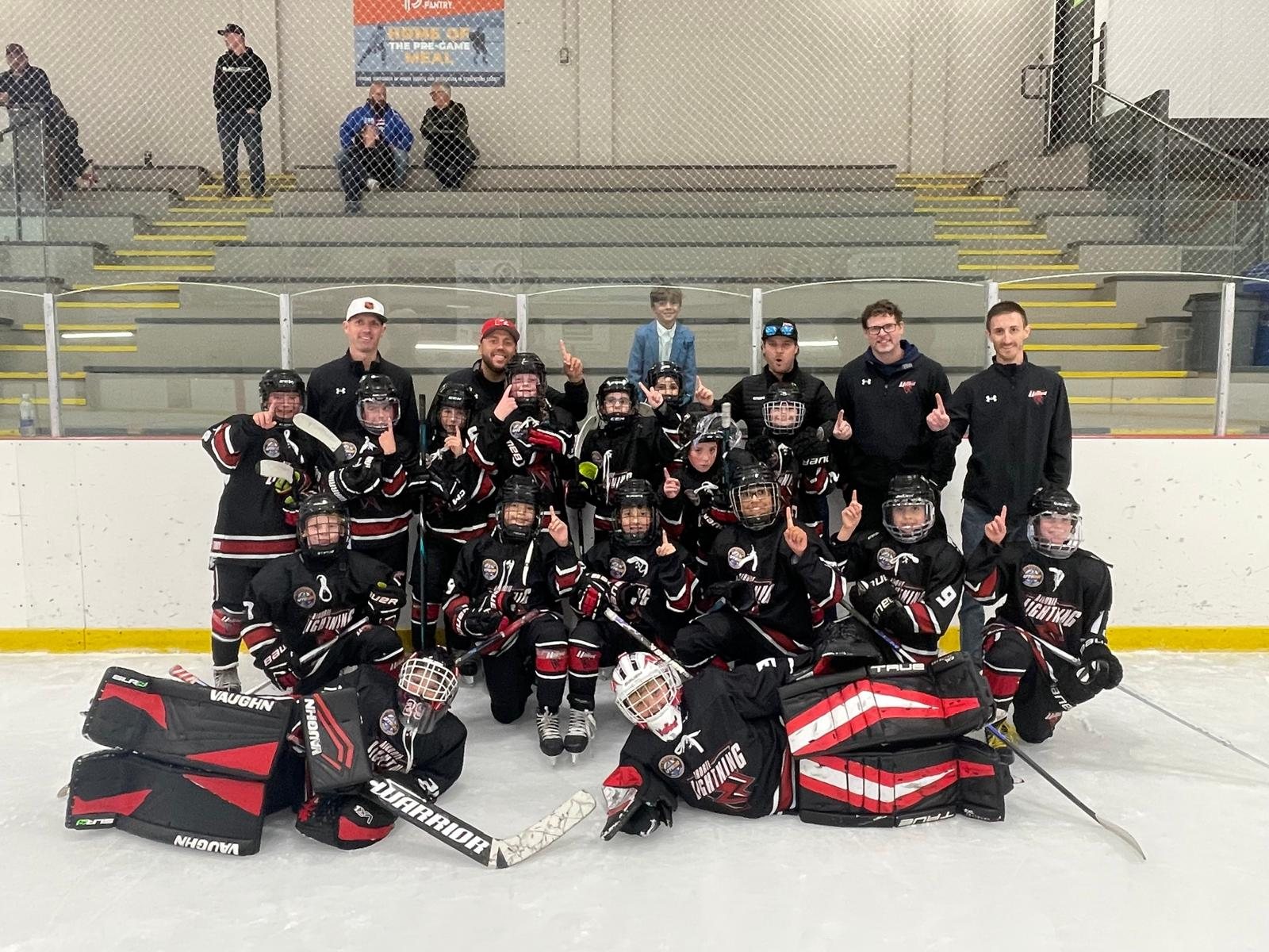 The Lightning team photo after winning the Ice Breaker final, with Max behind the glass